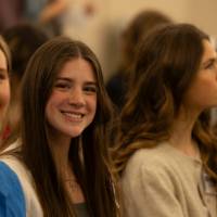 Students smiling in the crowd